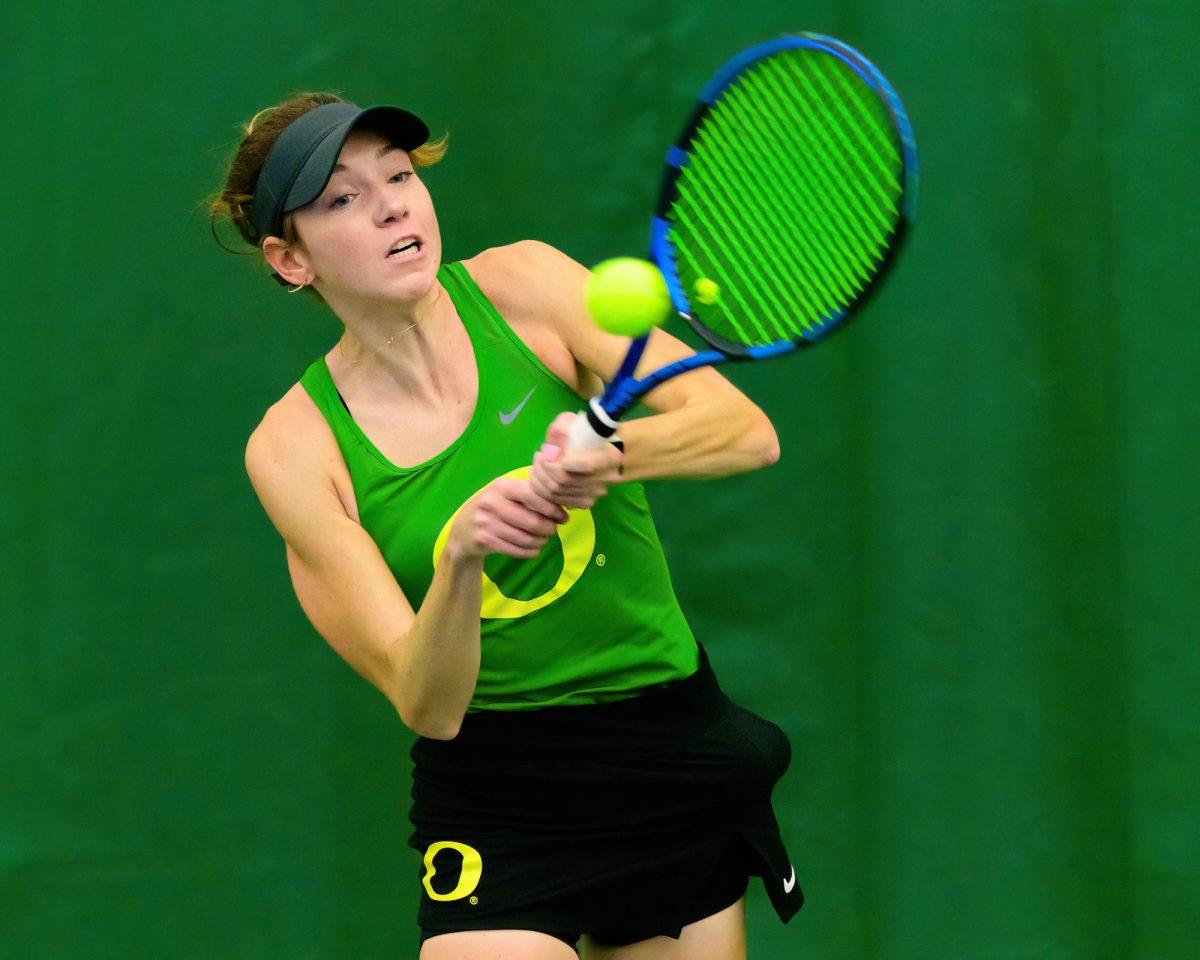 Karin Young sends the ball across the net using a two-handed backhand. The University of Oregon Ducks Women's Tennis team played the Eastern Washington University Eagles in a home match at the Student Tennis Center in Eugene, Ore., on Feb. 2, 2024. (Eric Becker/Emerald)