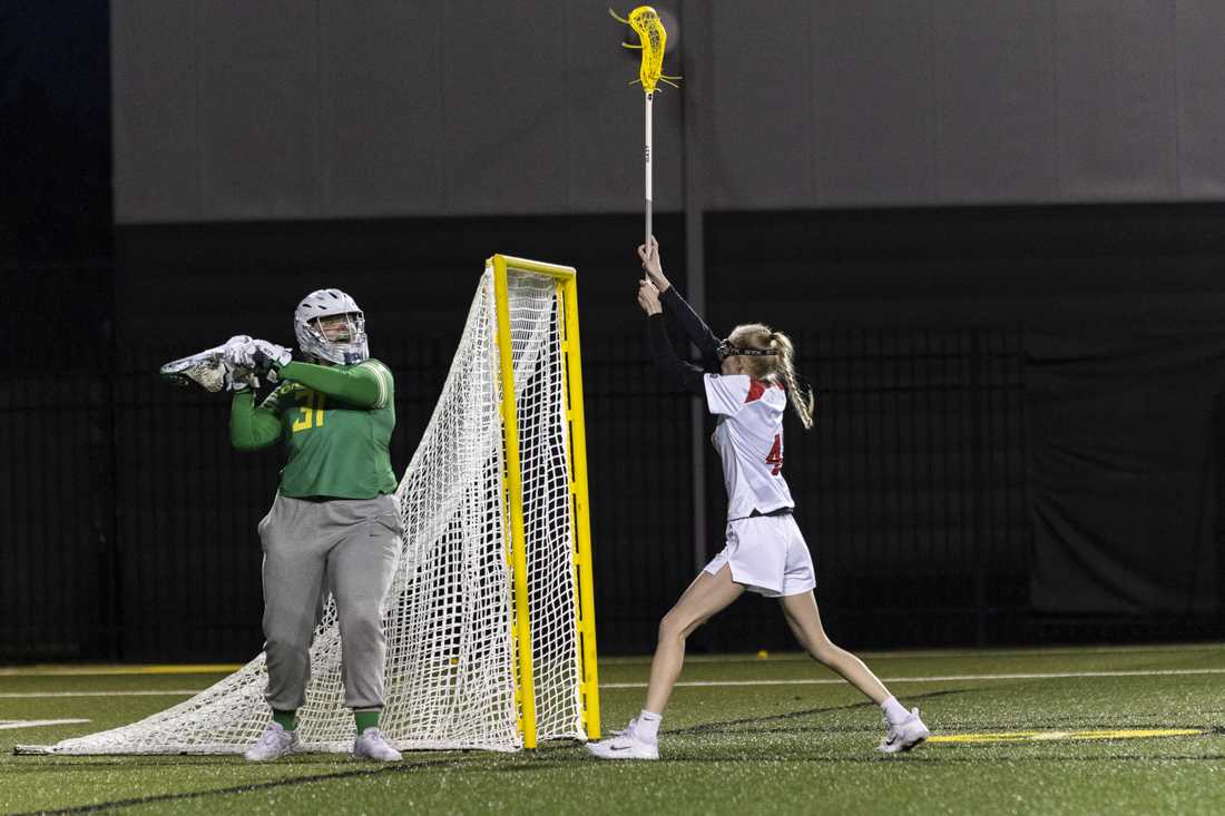 Oregon goalkeeper Thayer Hubbard looks to pass the ball. The Oregon Women's Lacrosse team won their match 19-8 against Youngstown State University at Pape Field on Feb. 9, 2024. (Alex Hernandez/Emerald)