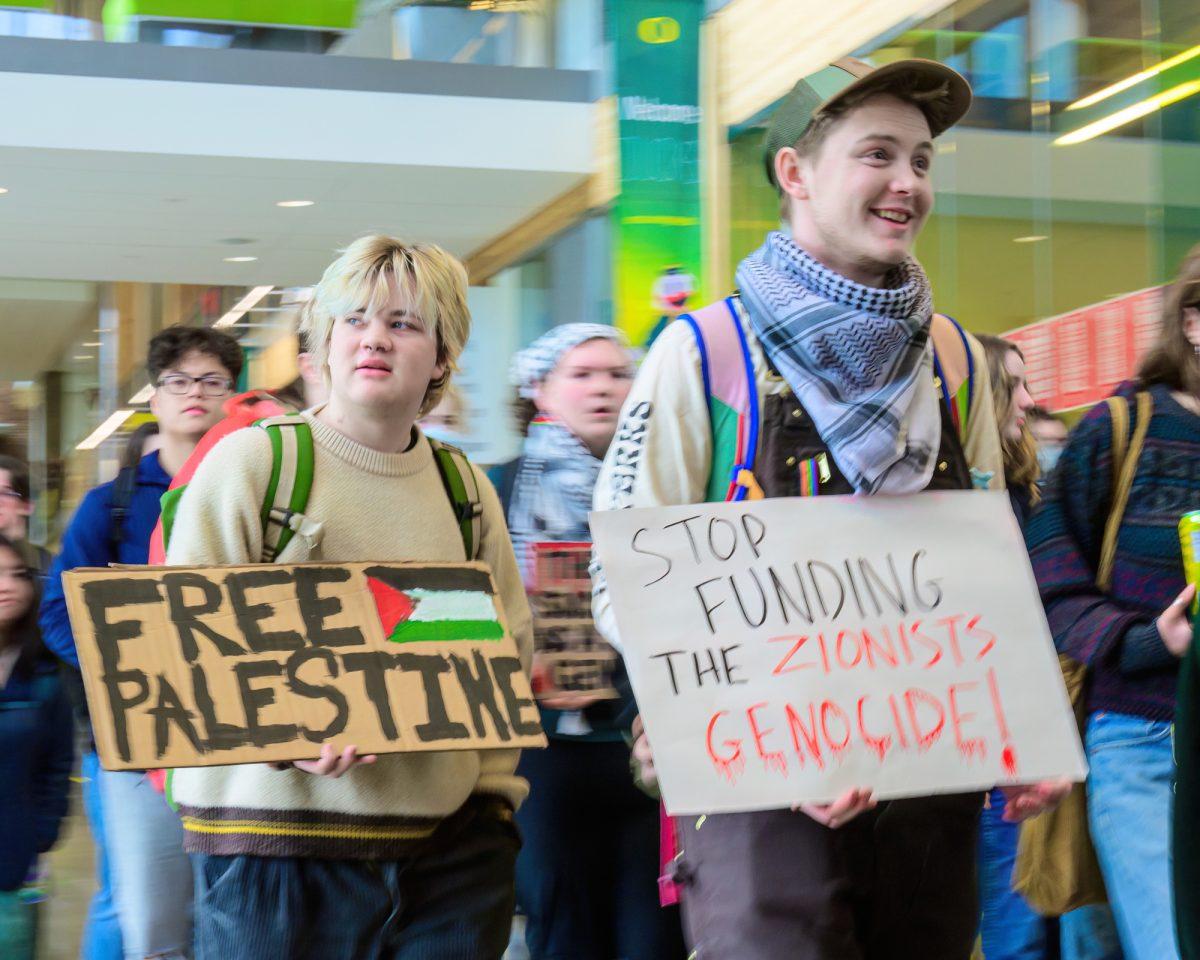 After the conclusion of several speeches, a large group of protesters began to march towards the exit of the EMU. The Walkout for Palestine protest began inside the Erb Memorial Union and expanded onto the grounds of the University of Oregon in Eugene, Ore., on Feb. 21, 2024. (Eric Becker/Emerald)