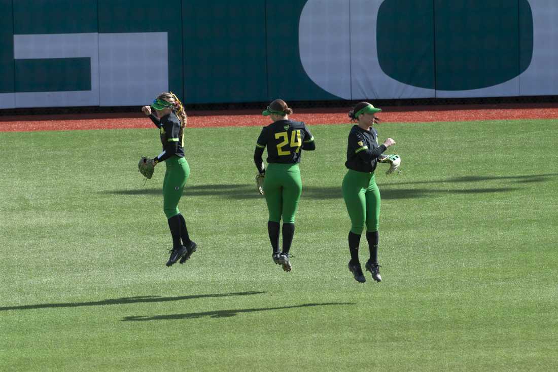 Oregon players spin and jump in the outfield. The Oregon women's softball team took a 5-2 win as they faced off against the University of California, Berkeley's Golden Bears at Jane Saunders Stadium on March 9, 2024. (Alex Hernandez/Emerald)