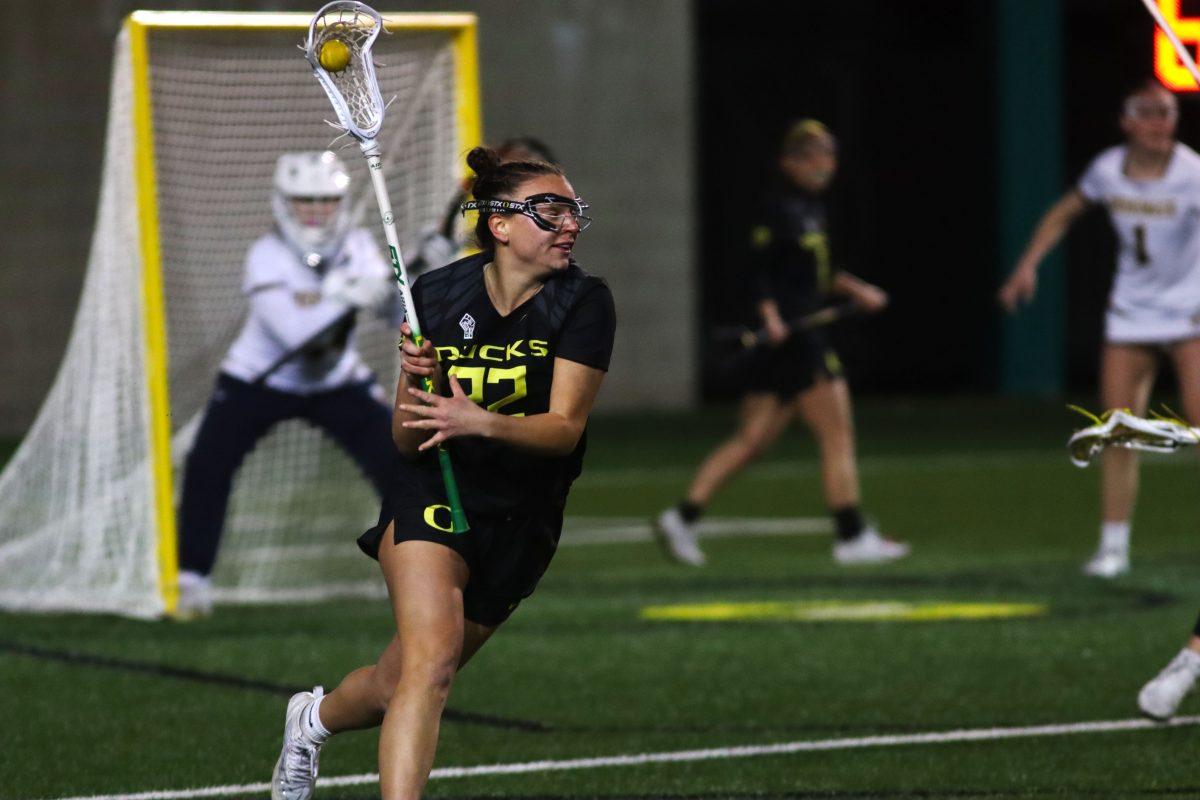 Jadyn Laing (22) cradling the ball. The Oregon Women&#8217;s Lacrosse team walks away with a win over Merrimack College 18-3 in their first game back from being on the road at Pap&#279; Field in Eugene, Ore., on March 6, 2024. (Alyssa Garcia/Emerald)