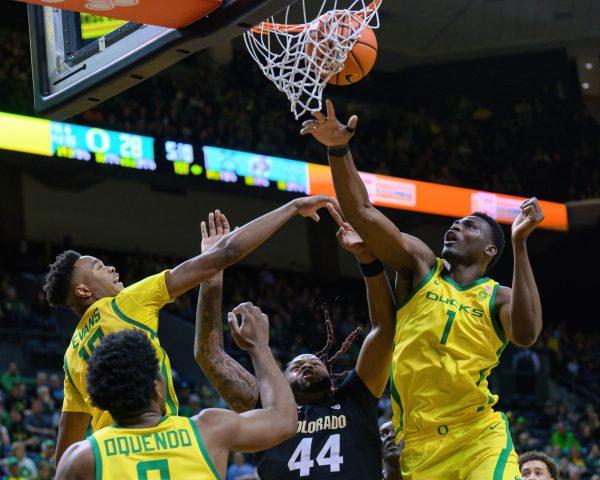 <p>Oregon Center N'Faly Dante #1 (right) and Forward Kwame Evans Jr. #10 (left) fight for a rebound with Colorado Center Eddie Lampkin Jr. (middle) under the basket. The University of Oregon Ducks Men's Basketball team was defeated by the University of Colorado Buffaloes 79-75 in a home game at Matthew Knight Arena in Eugene, Ore., on March 7, 2024. (Eric Becker/Emerald)</p>