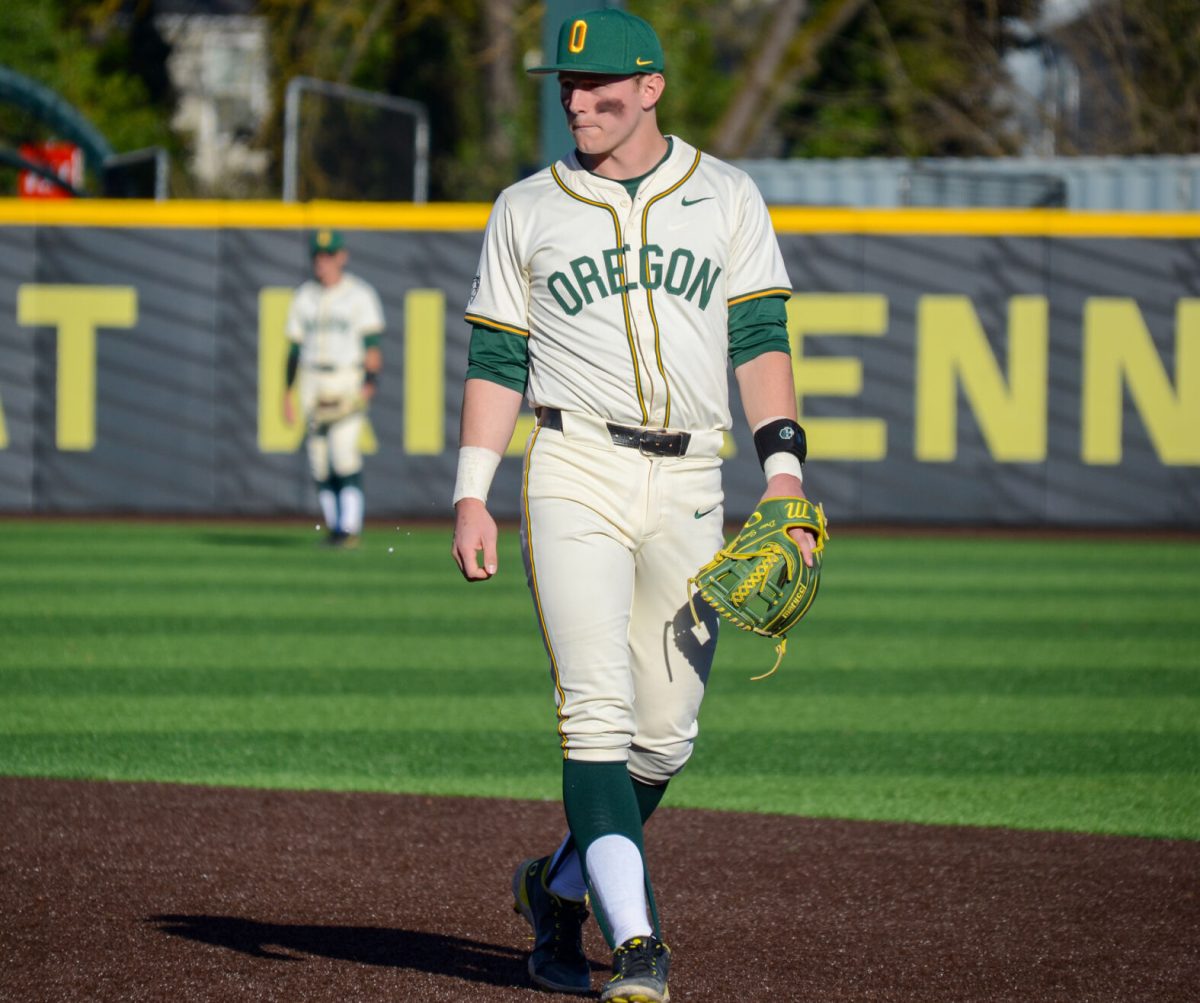 Drew Smith (17) shows off the Oregon throwback uniforms. (Kai Kanzer/Emerald)