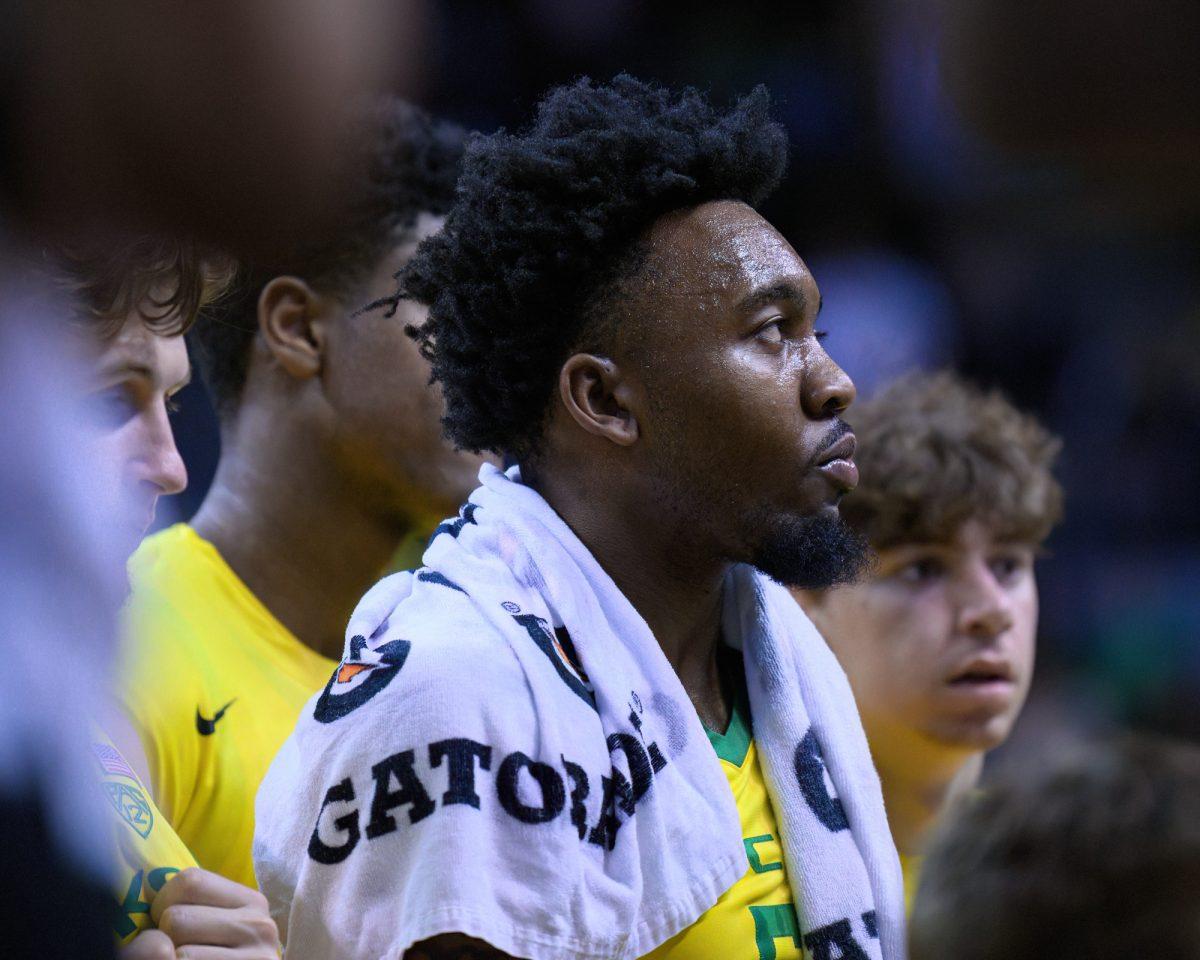 Oregon Guard Jermaine Couisnard #5 listens to Head Coach Dana Altman during a timeout. The University of Oregon Ducks Men's Basketball team was defeated by the University of Colorado Buffaloes 79-75 in a home game at Matthew Knight Arena in Eugene, Ore., on March 7, 2024. (Eric Becker/Emerald)