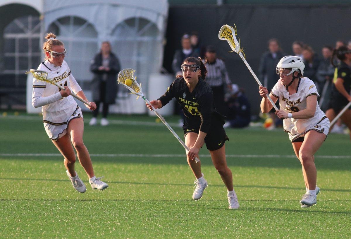 Jenae Sperling (19) takes off with the ball as Samantha Spieler (11) and Holly Schweitzer (19) run after her. The Oregon Women&#8217;s Lacrosse team walks away with a win over Merrimack College 18-3 in their first game back from being on the road at Pap&#279; Field in Eugene, Ore., on March 6, 2024. (Alyssa Garcia/Emerald)