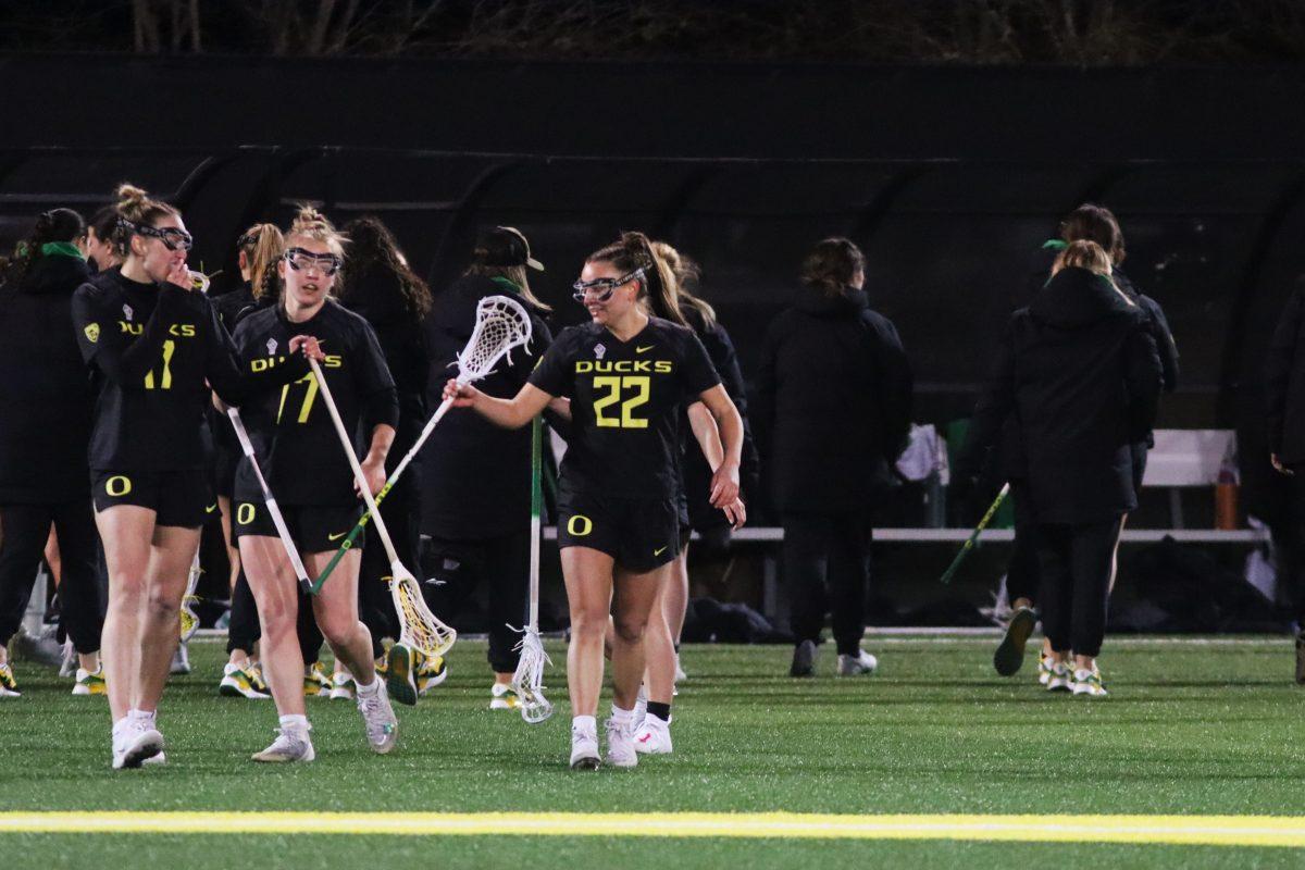 Kristiana Strtak (17) and Jadyn Laing (22) bump sticks with seconds remaining in the game. The Oregon Women&#8217;s Lacrosse team walks away with a win over Merrimack College 18-3 in their first game back from being on the road at Pap&#279; Field in Eugene, Ore., on March 6, 2024. (Alyssa Garcia/Emerald)