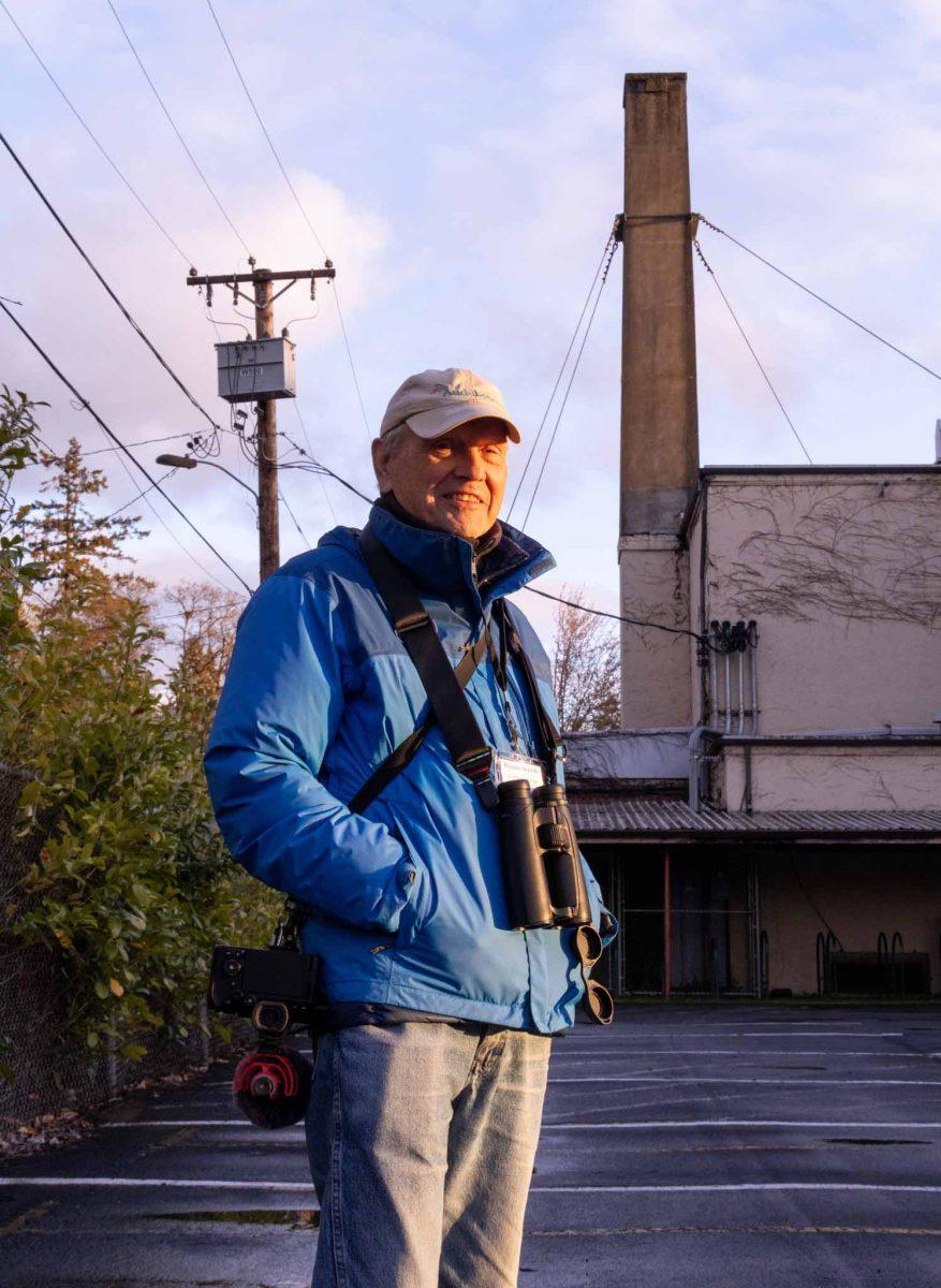 Dennis Arendt has been a member of the Lane County Audubon Society for 39 years. He stands in front of the Chimney at Agate Hall, the second largest Vaux Swift roost site in Oregon.