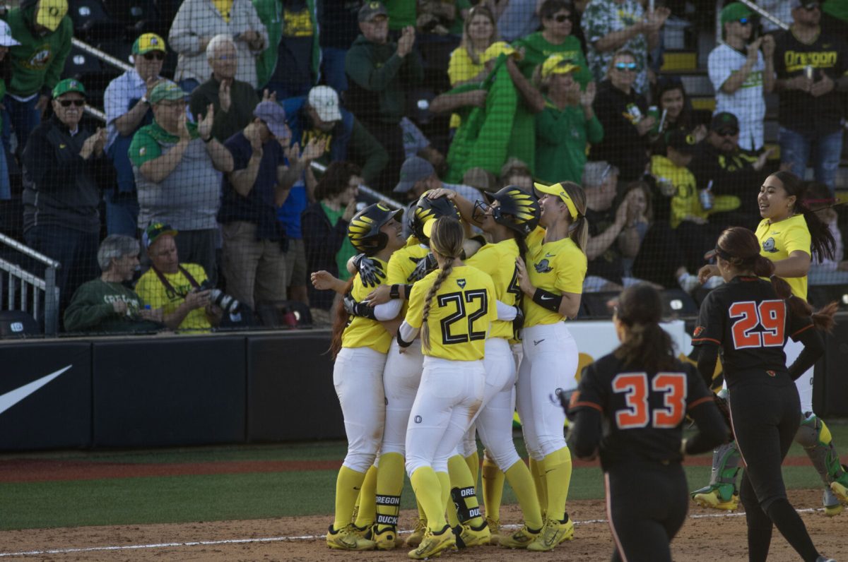 Oregon players celebrate the victory after Katie Flannery (6) hits a single to walk off the game. The Oregon Softball team secures the win 11-3 over Oregon State in game 1 of their Rivalry Series, hosted at Jane Sanders Stadium in Eugene, Ore., on April 19, 2024. (Alyssa Garcia/Emerald)