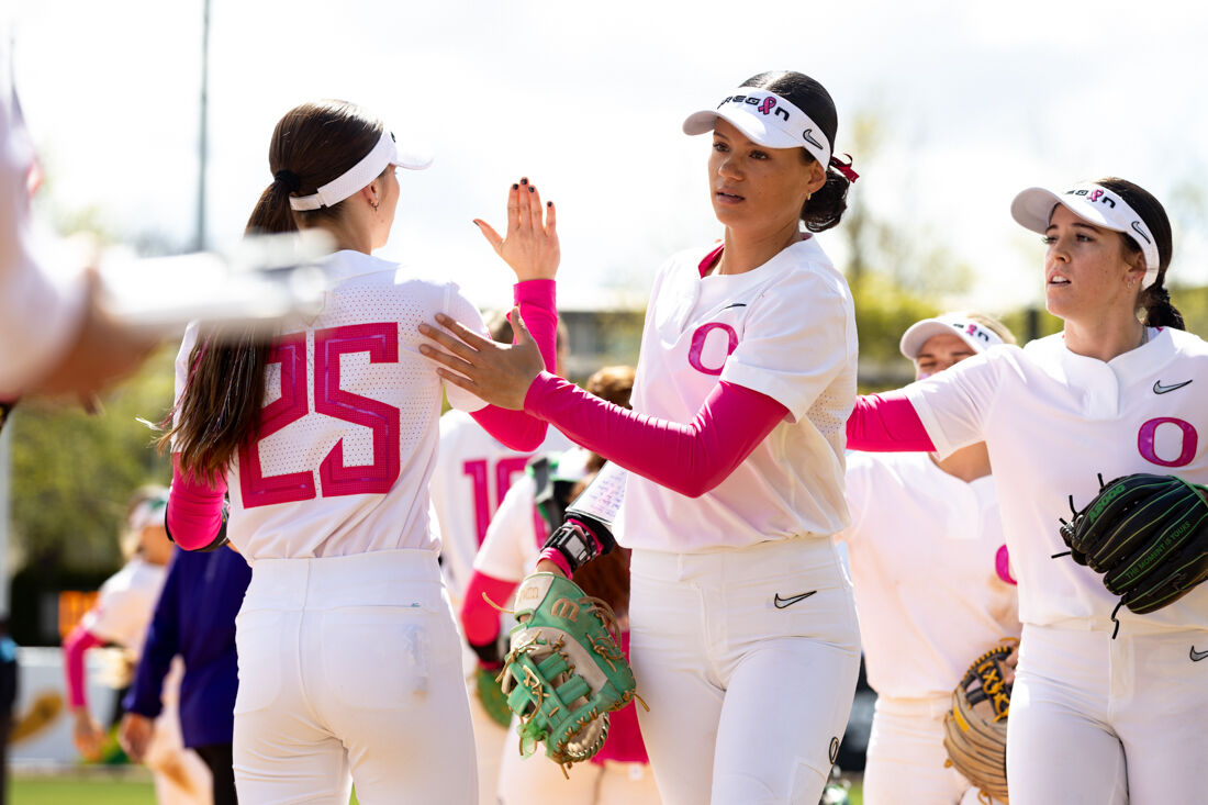 The Ducks come in and high five each other after successful plays in the fourth inning. The University of Oregon Softball team defeated University of Washington 6-4 in a Pac-12 series at Jane Sanders Stadium in Eugene, Ore., on April 7, 2024. (Kemper Flood/Emerald)