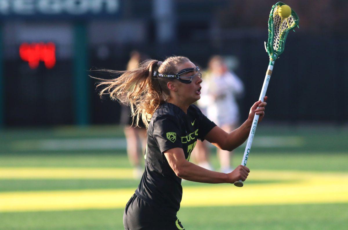 Riley Taylor (27) looking to pass the ball. The Oregon Women&#8217;s Lacrosse team walks away with a win over Merrimack College 18-3 in their first game back from being on the road at Pap&#279; Field in Eugene, Ore., on March 6, 2024. (Alyssa Garcia/Emerald)