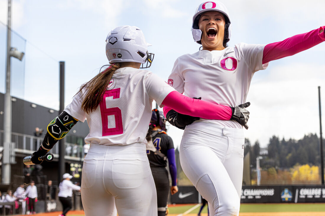 Alyssa Daniell (10) and Katie Flannery (6) celebrate after Daniell hit a double to left-center to scare three for the Ducks. The University of Oregon Softball team defeated University of Washington 6-4 in a Pac-12 series at Jane Sanders Stadium in Eugene, Ore., on April 7, 2024. (Kemper Flood/Emerald)