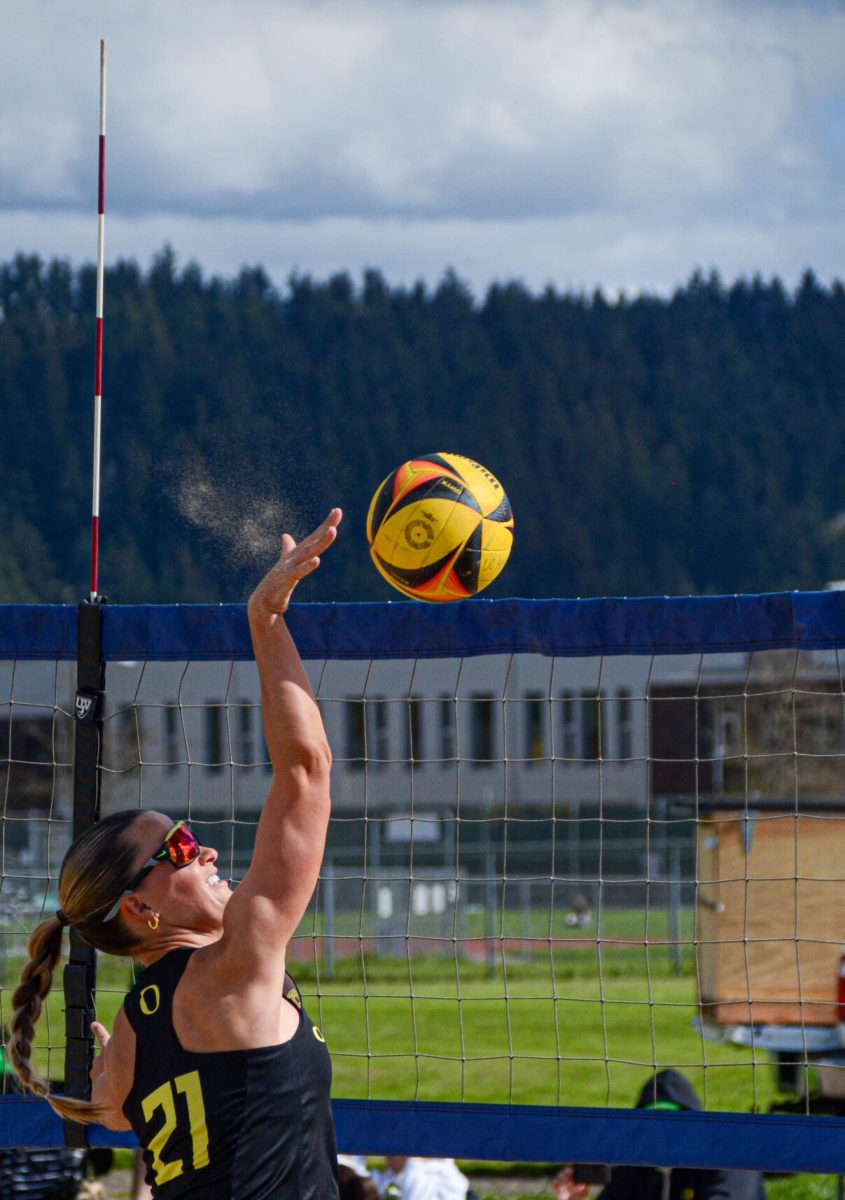 Natasha George (21) spikes the ball over the net as the Ducks complete a sweep with a 21-19, 21-10 win at the No. 4 pairs. This was Georges 20th career win, puting her at top 10 Oregon wins of all time. The Oregon Beach Volleyball Team defeat Bushnell 5-0 on Senior Day on April 9, 2024 at Amazon Park in Eugene, Ore. (Kai Kanzer/Emerald)