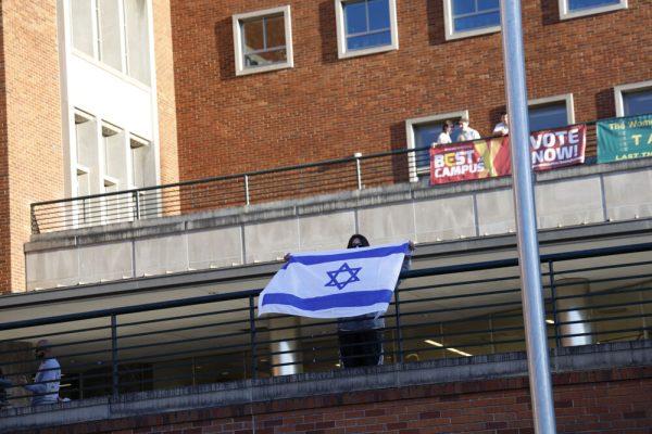 <p>A person holds an Israeli flag toward the protesters outside of the EMU on April 18, 2024. The UO Students for Justice in Palestine and Jewish Voice for Peace demonstration was held in protest of an event organized by the student group Ducks 4 Israel—"60 Days of Uncertainty," a presentation and Q&A by former IDF soldier, Adiel Cohen. (Alex Hernandez/Emerald)</p>