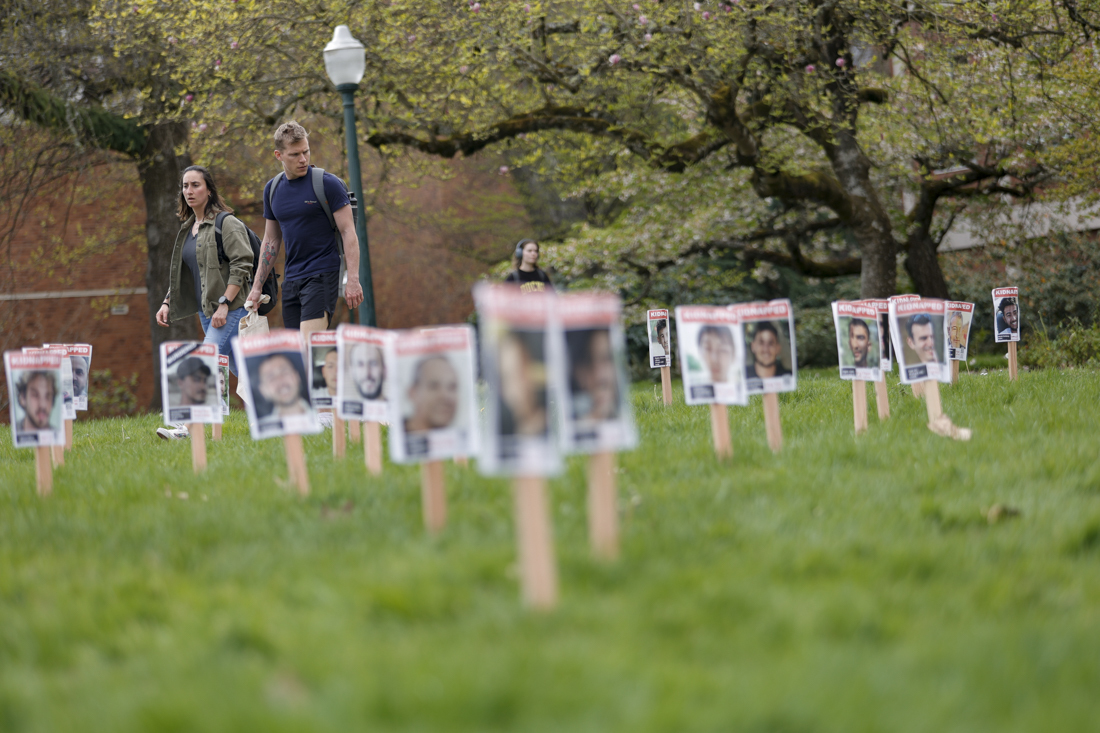 Signs outside of the UO Lillis Business Complex show images of people who have been kidnapped or killed by Hamas throughout the Israel-Hamas War on April 8, 2024.