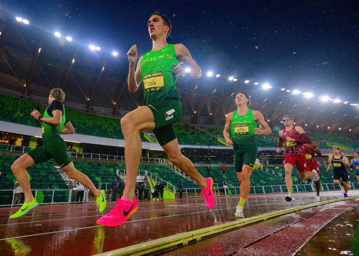 A group of three Oregon runners, lead by Elliott Cook lead the Men's 5000m after the first lap. The University of Oregon Ducks Track and Field team hosted the Oregon Twilight Meet at Hayward Field in Eugene, Oregon, on May 3, 2024. (Eric Becker/Emerald)