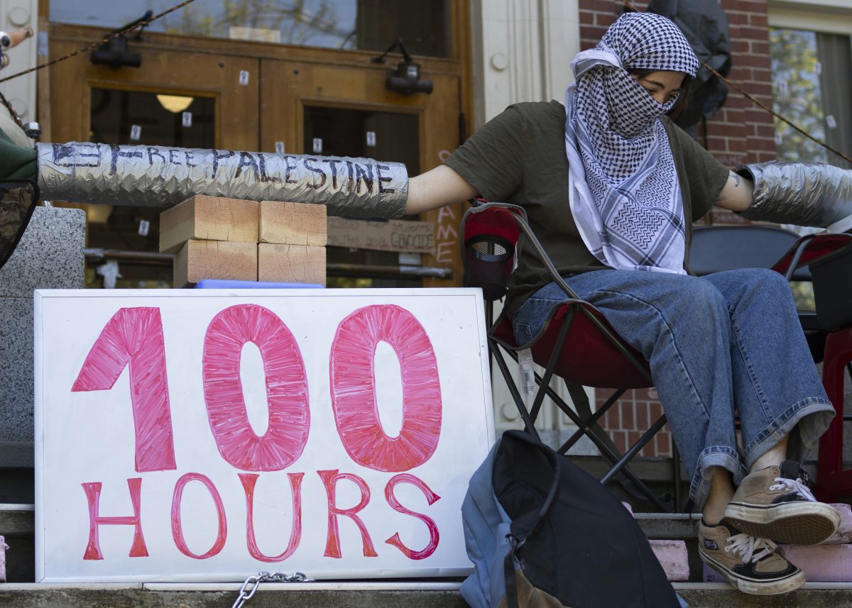 Protesters gathered on May 20, 2024, for a "100 Hours in Chains" rally in front of Johnson Hall&#8212;now "renamed" by protesters to "Alareer Hall," after writer and poet Refaat Alareer, who was killed in Gaza&#8212;with students who had chained themselves to the building removing their chains before marching through other buildings on campus; the rally is the most recent in a series of pro-Palestine demonstrations on the UO campus. (Colleen Bogdan/Emerald)