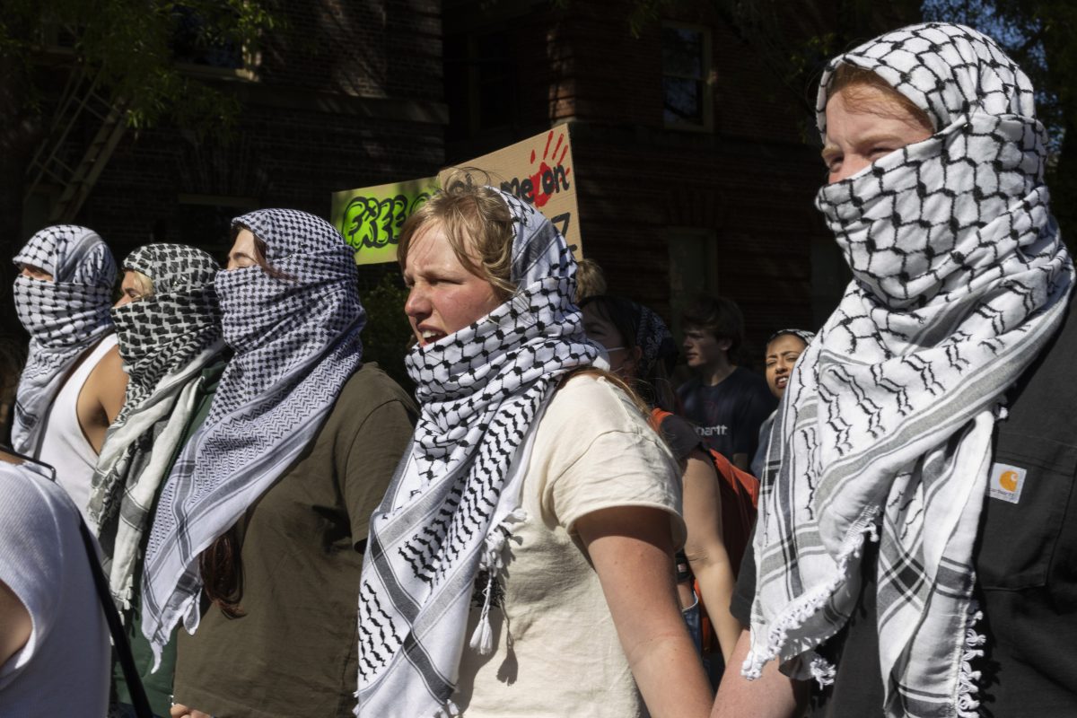 The five chained protesters lead the march down 13th Avenue. Protesters gathered on May 20, 2024, for a "100 Hours in Chains" rally in front of Johnson Hall&#8212;now "renamed" by protesters to "Alareer Hall," after writer and poet Refaat Alareer, who was killed in Gaza&#8212;with students who had chained themselves to the building removing their chains before marching through other buildings on campus; the rally is the most recent in a series of pro-Palestine demonstrations on the UO campus. (Colleen Bogdan/Emerald)