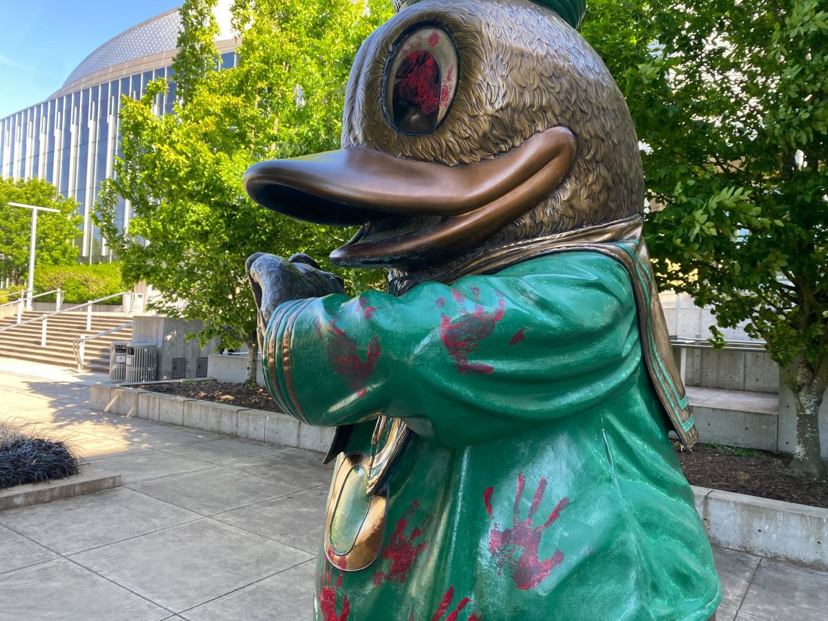 Pro-Palestine protestors interrupted UO President John Karl Scholz&#8217; investiture ceremony, held inside Matthew Knight Arena and later vandalized the Duck statue outside of the arena, as well as windows, with red paint. (Norgren/Emerald)