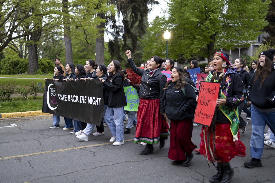 Members of UO student groups like Muxeres (left) and NASU (right) lead the 46th annual Take Back The Night march on April 25, 2024. The event, hosted by the UO Women's Center, includes a rally, march, and student "speak-out," and is part of a larger international movement to support individuals who have experienced sexual violence. (Alex Hernandez/Emerald)