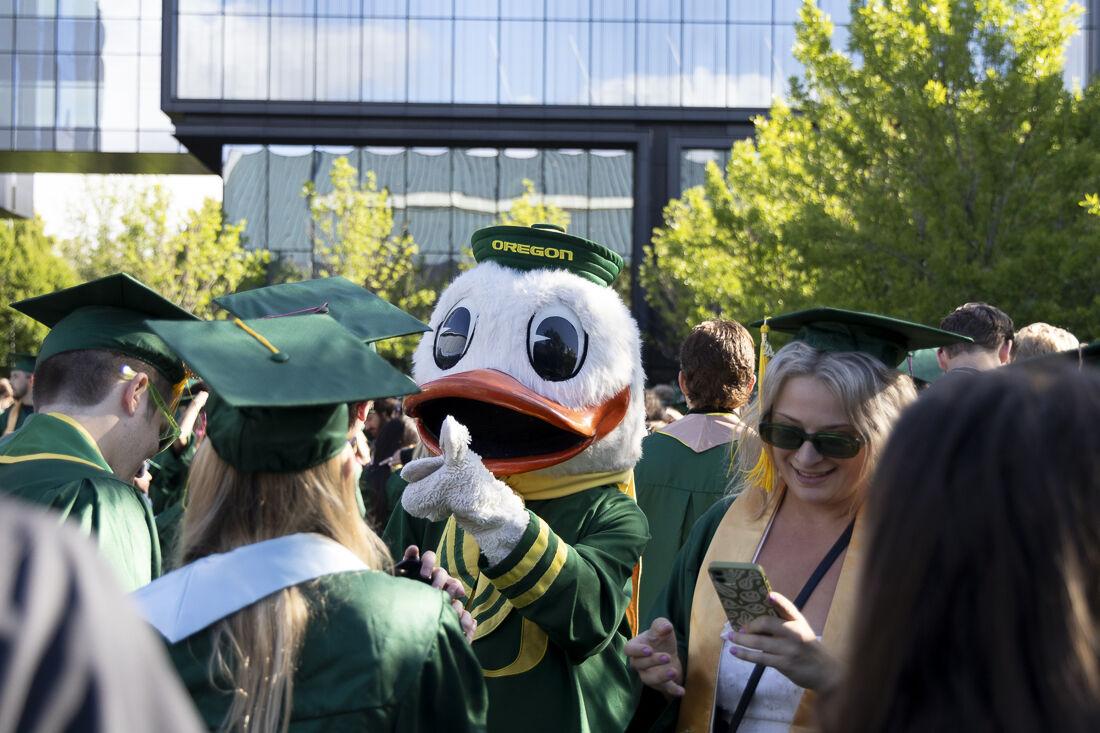 The Oregon Duck walks through the crowd of graduates before the commencement ceremony. The 147th University of Oregon Commencement Ceremony took place on June 17, 2024 in Autzen Stadium in Eugene, Ore. (Alex Hernandez/Emerald)