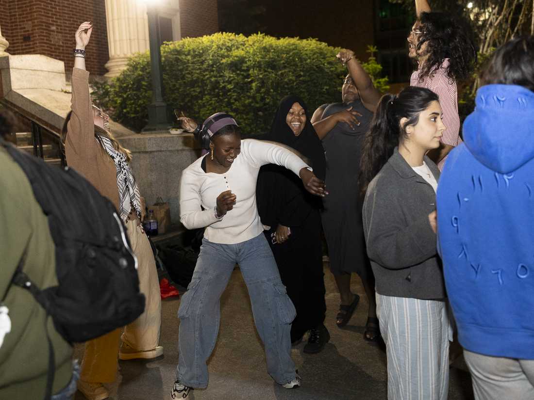 Demonstrators dance in celebration outside of Johnson Hall on May 22, 2024. After weeks of protest, the 24-day-long encampment demonstration saw its end after negotiations teams from the encampment and the University of Oregon reached an agreement to end the encampment in exchange for meeting some student demands, including "No adverse action" for "protected speech" activities, a call for a ceasefire in Gaza, and more. (Alex Hernandez/Emerald)