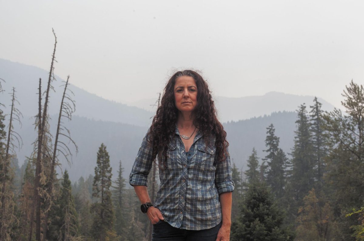 Michelle Emmons stands amongst burnt trees near Oakridge, Ore. As a candidate for Oregon House 
District 12, she hopes to address her constituencies’ natural disaster response. (Miles Cull/Emerald)