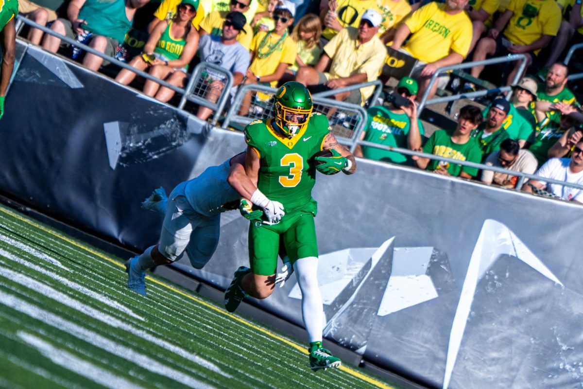 Tight end Terrance Ferguson (3) runs down the field while being tackled from behind. The Oregon Ducks football team takes on the Idaho Vandals on Aug. 31, 2024 at Autzen Stadium in Eugene, Ore. (Spencer So/Emerald) 