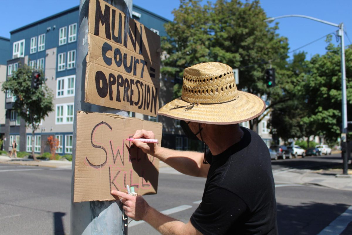 On Aug. 6, unhoused activists protested outside of the Eugene Municipal Courthouse, demonstrating against the city’s policy of sweeping homeless camps. (Mathias Lehman-Winters/Emerald)