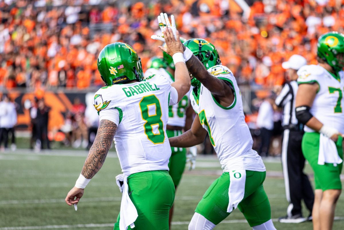 Dillon Gabriel (8) and Evan Stewart (7) celebrate another Oregon touchdown as they begin to widen their lead against the Oregon State Beavers. The Oregon Ducks travel up to Corvallis to face their in-state rival the Oregon State Beavers on September 14th, 2024. (Jonathan Suni, Emerald)