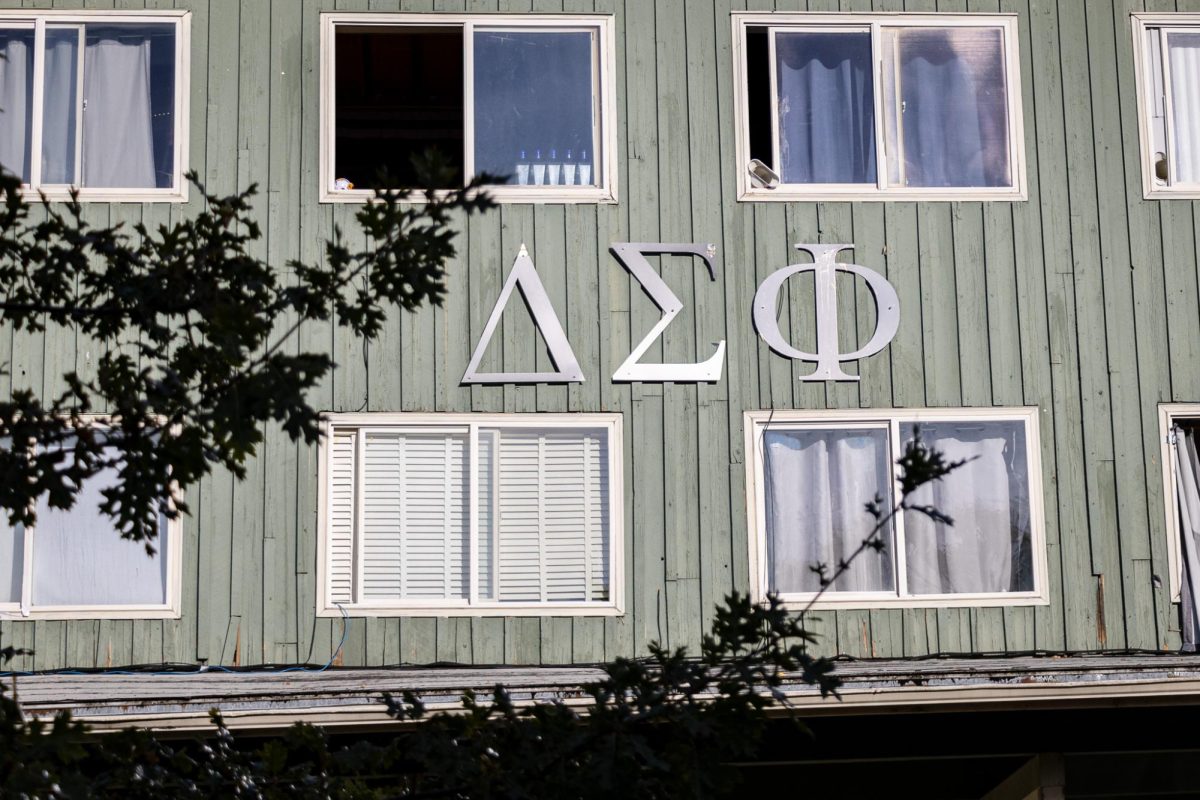 The late summer sun hits the Delta Sigma Phi house as the surrounding tree leaves begin to fall. (Jonathan Suni/Emerald)