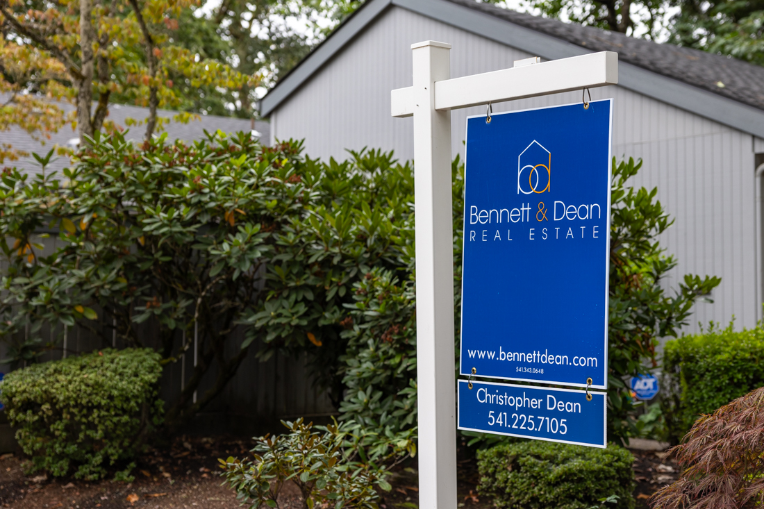 A real estate listing sign sits in the yard of a home in the Cal Young neighborhood of Eugene. (Molly McPherson/Emerald)