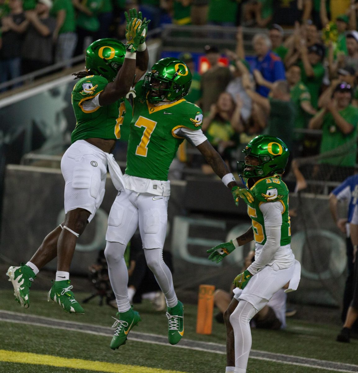 Noah Whittington, (6) Jabbar Muhammad, (7) and Solomon Davis celebrate after a touchdown. The University of Oregon Ducks defeated the Boise State Broncos 37-34. 