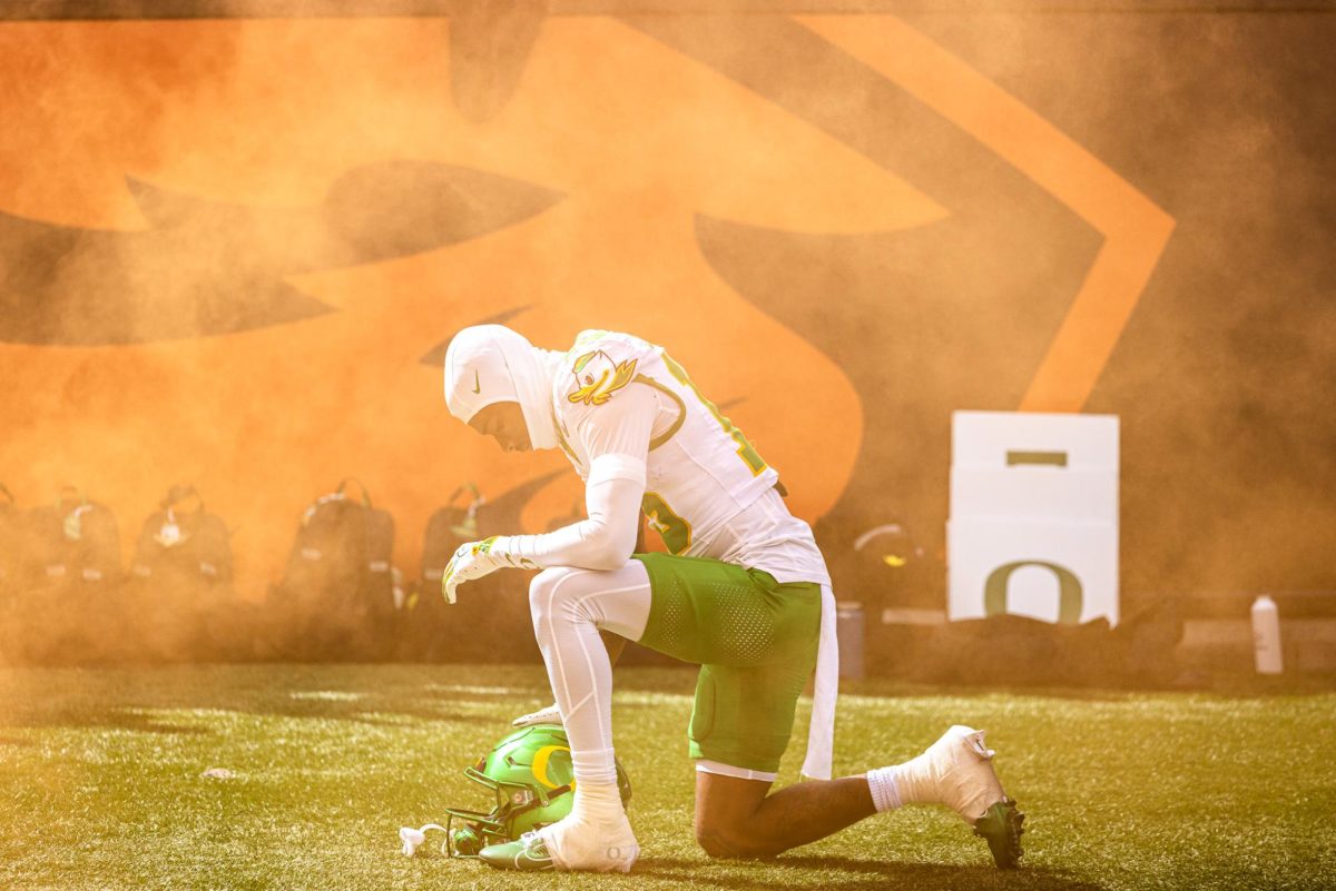 Star receiver for the Oregon Ducks, Tee Johnson (15), takes a moment to himself as he is surrounded by Beaver Orange smoke. The Oregon Ducks travel up to Corvallis to face their in-state rival the Oregon State Beavers on September 14th, 2024. (Jonathan Suni/Emerald)