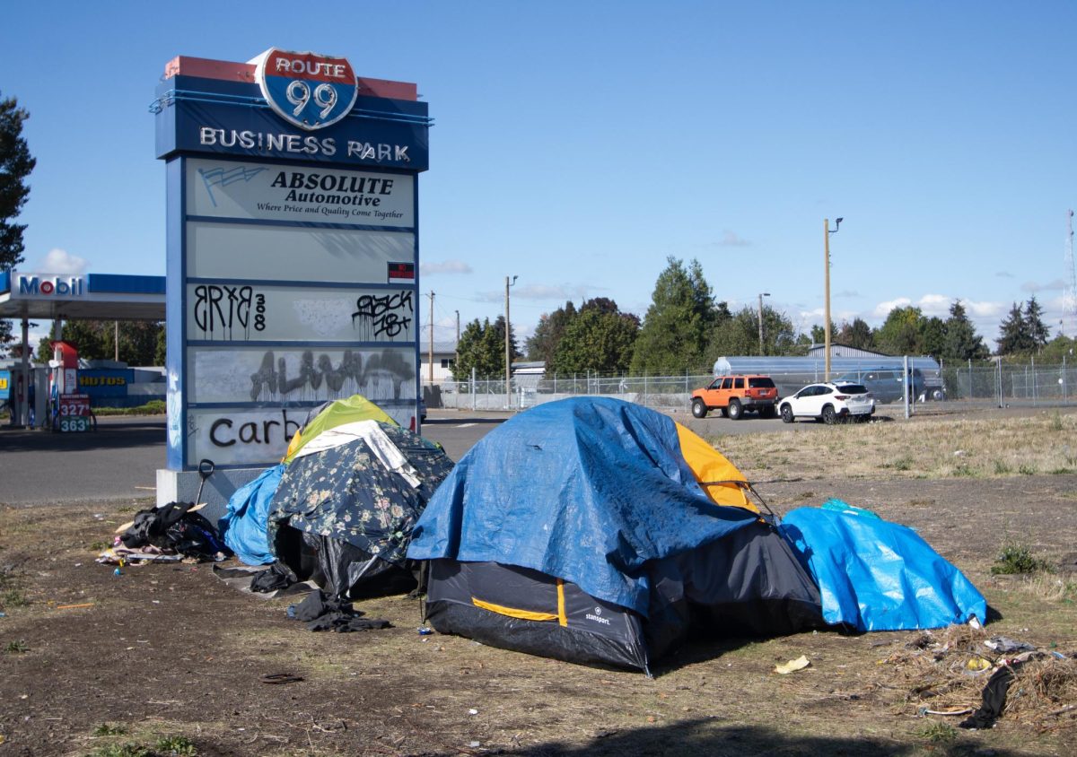 Three unhoused tents set up next to the Mobil gas station off of Highway 99N in Eugene. (Anna Liv Myklebust/Emerald)