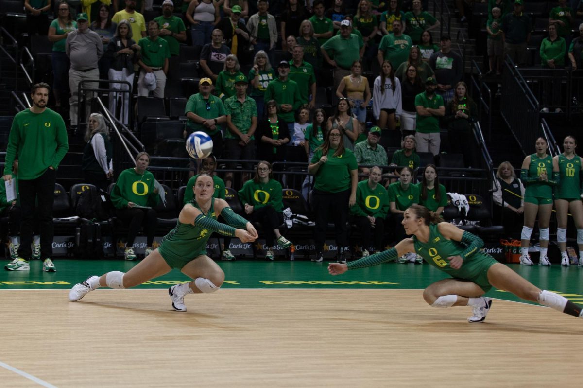 Bella Gamache (5) and Sophie Gregoire (6) dive for a spiked ball. The University of Oregon Ducks crushed the Oregon State Beavers 3-0 Sunday. (Miles Cull/Emerald)