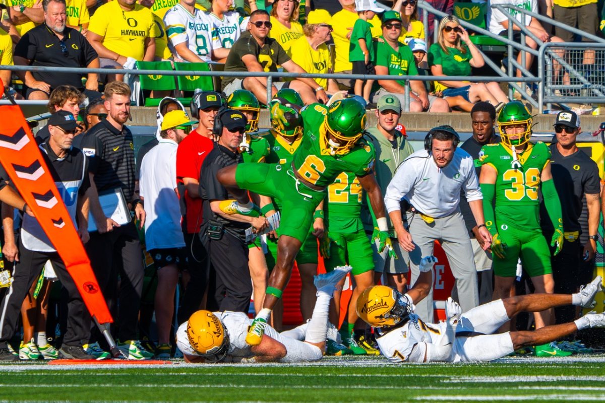 Noah Whittington(6) leaps over two defenders. The University of Oregon Ducks Football team played the University of Idaho in a home match at Autzen Stadium in Eugene, Ore., on August 31st, 2024. (Spencer So/Emerald)