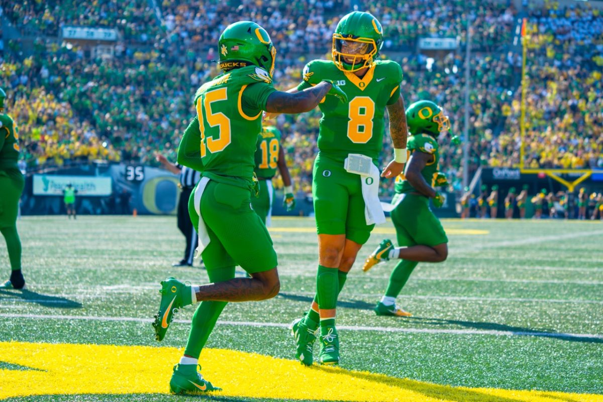 Dillon Gabriel(8) celebrates his first touchdown to Tez Johnson(15) as an Oregon Duck. The University of Oregon Ducks Football team played the University of Idaho in a home match at Autzen Stadium in Eugene, Ore., on August 31st, 2024. (Spencer So/Emerald)