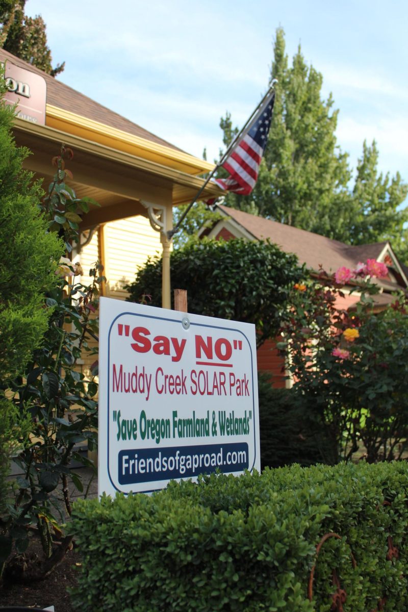 Anti-Muddy Creek Solar Park sign sits outside of a local business in Coburg, Ore., in 2024. (Mathias Lehman-Winters/Emerald)