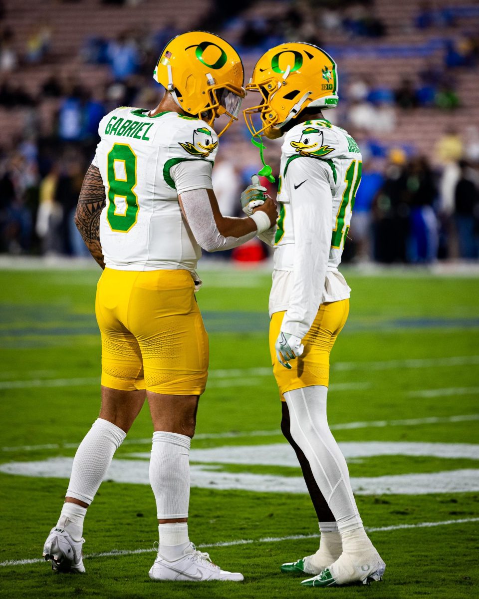 Dillon Gabriel (8) and Tez Johnson (15) take a moment to themselves before heading into the locker room one last time before the start of the game. The Oregon Ducks take on the UCLA Bruins in its first Big Ten Conference game in the Rose Bowl in Pasadena, CA on Sept. 28, 2024. (Jonathan Suni/Emerald)