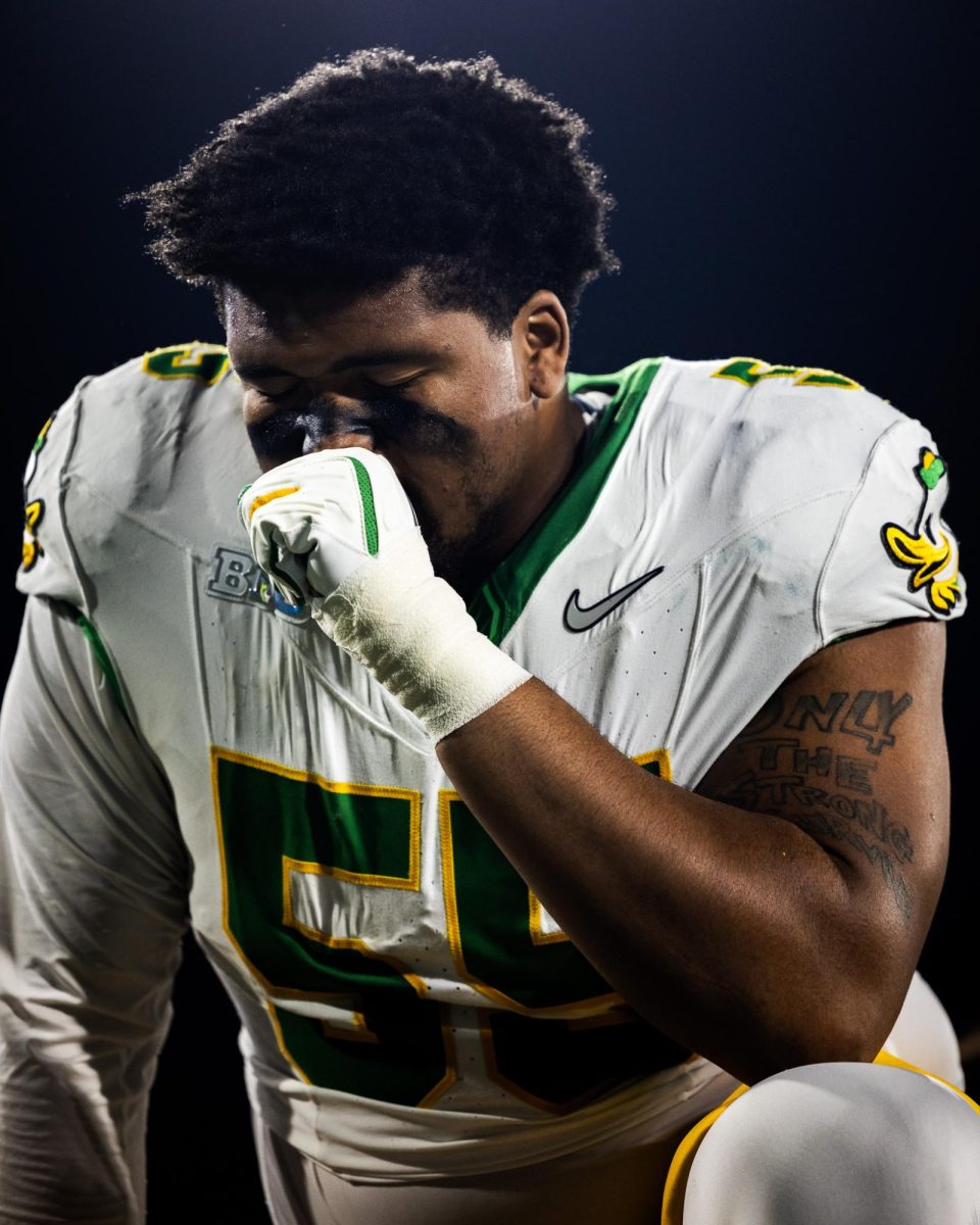 Major defensive transfer, Derrick Harmon (55), prays in the end zone after running out with his team. The Oregon Ducks take on the UCLA Bruins in its first Big Ten Conference game in the Rose Bowl in Pasadena, CA on Sept. 28, 2024. (Jonathan Suni/Emerald)