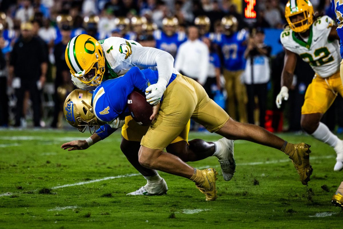 Immediately after a big backfield tackle, Jordan Burch (1) sacks the UCLA quarterback to add even more yardage for the Bruins. The Oregon Ducks take on the UCLA Bruins in its first Big Ten Conference game in the Rose Bowl in Pasadena, CA on Sept. 28, 2024. (Jonathan Suni/Emerald)