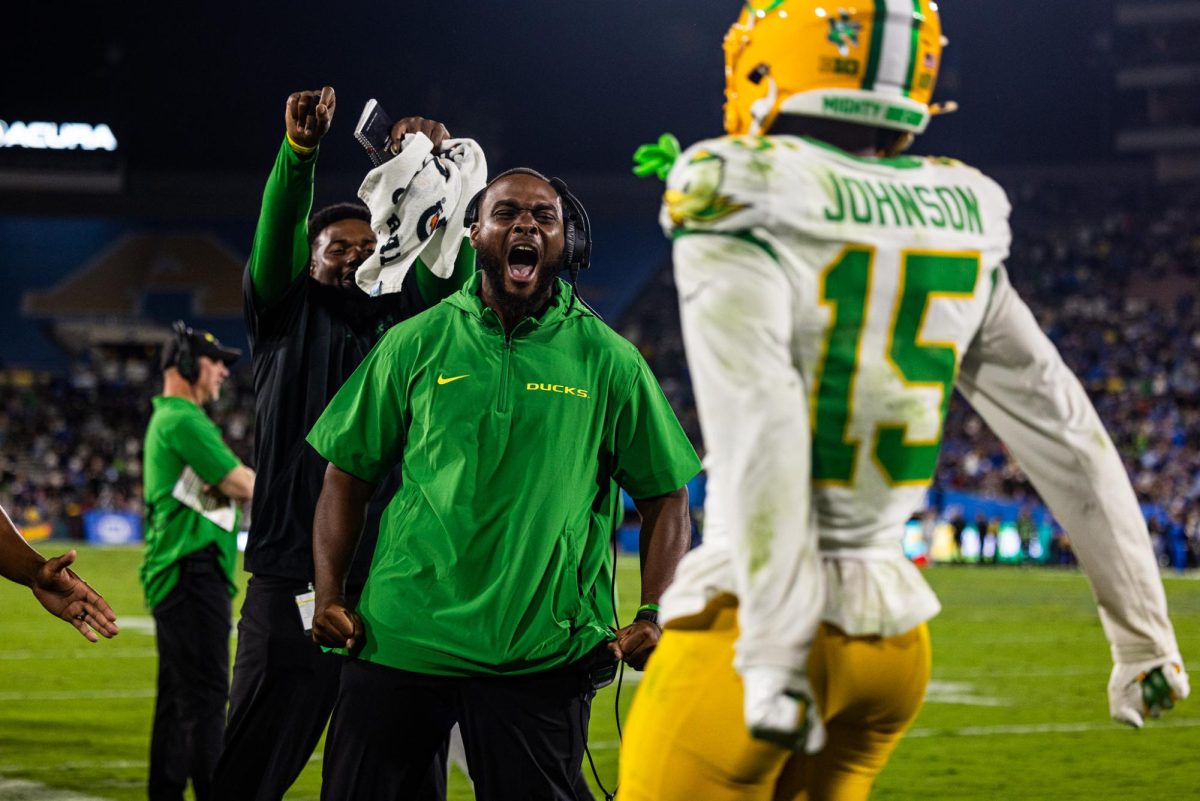 Offensive line coach, A'lique Terry, celebrates Tez Johnson's (15) second touchdown of the game. The Oregon Ducks take on the UCLA Bruins in its first Big Ten Conference game in the Rose Bowl in Pasadena, CA on Sept. 28, 2024. (Jonathan Suni/Emerald)