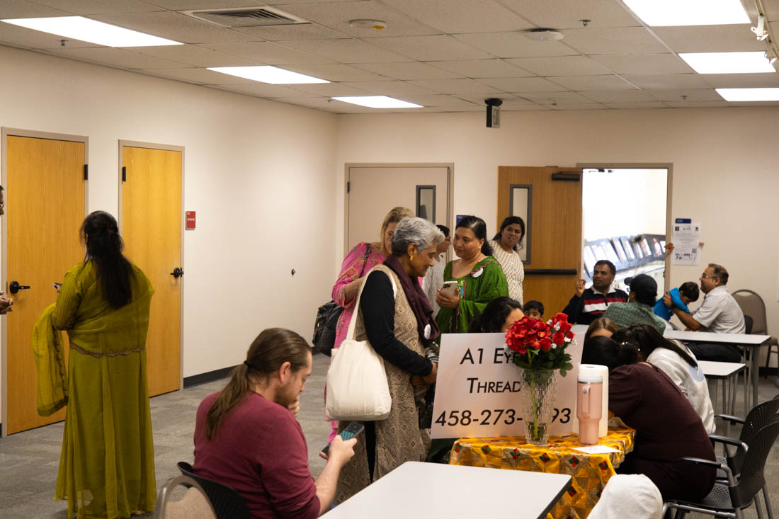 Families gather and converse outside the performance hall. Desi Fest, at Lane Community College, celebrated South Asian culture with performances, food, and activities on Oct. 5, 2024. (Mason Cruz/Emerald)