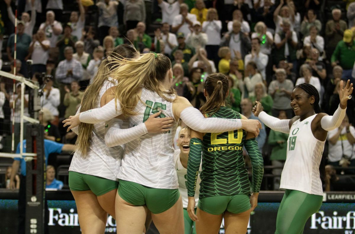 Oregon celebrates after winning the first set. The Oregon volleyball team completes a sweep over No. 16 University of Southern California 3-0 on Oct. 9, 2024, at Matthew Knight Arena in Eugene, Ore. (Alyssa Garcia/Emerald) 