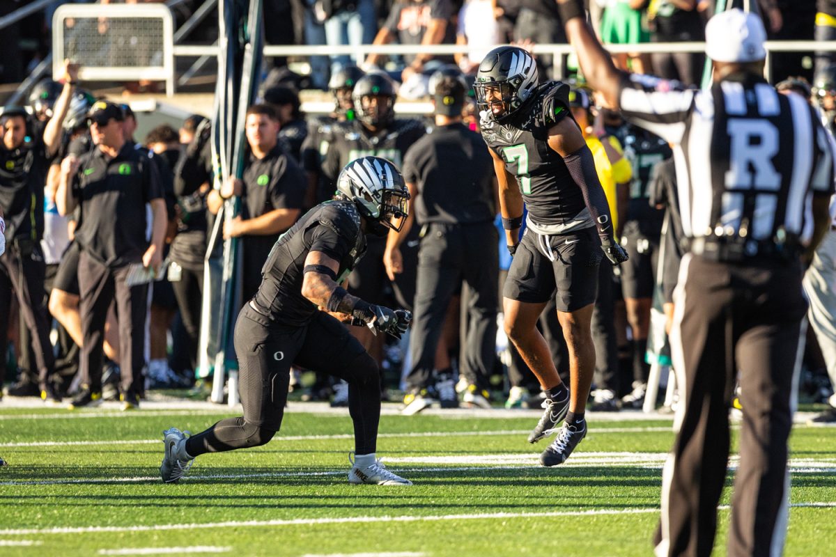 Oregon's Kobe Savage (5) and Jabbar Muhammad (7) celebrate together after a big play. The number 3 ranked Oregon Ducks football team takes on the number 2 ranked Ohio State University Buckeyes on Oct. 12, 2024, at Autzen Stadium in Eugene, Ore. (Molly McPherson/Emerald)