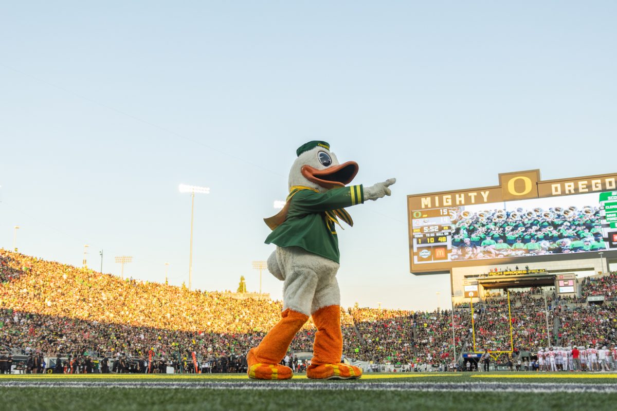 The Duck dances to the television camera as the sun begins to set. The number 3 ranked Oregon Ducks football team takes on the number 2 ranked Ohio State University Buckeyes on Oct. 12, 2024, at Autzen Stadium in Eugene, Ore. (Molly McPherson/Emerald)