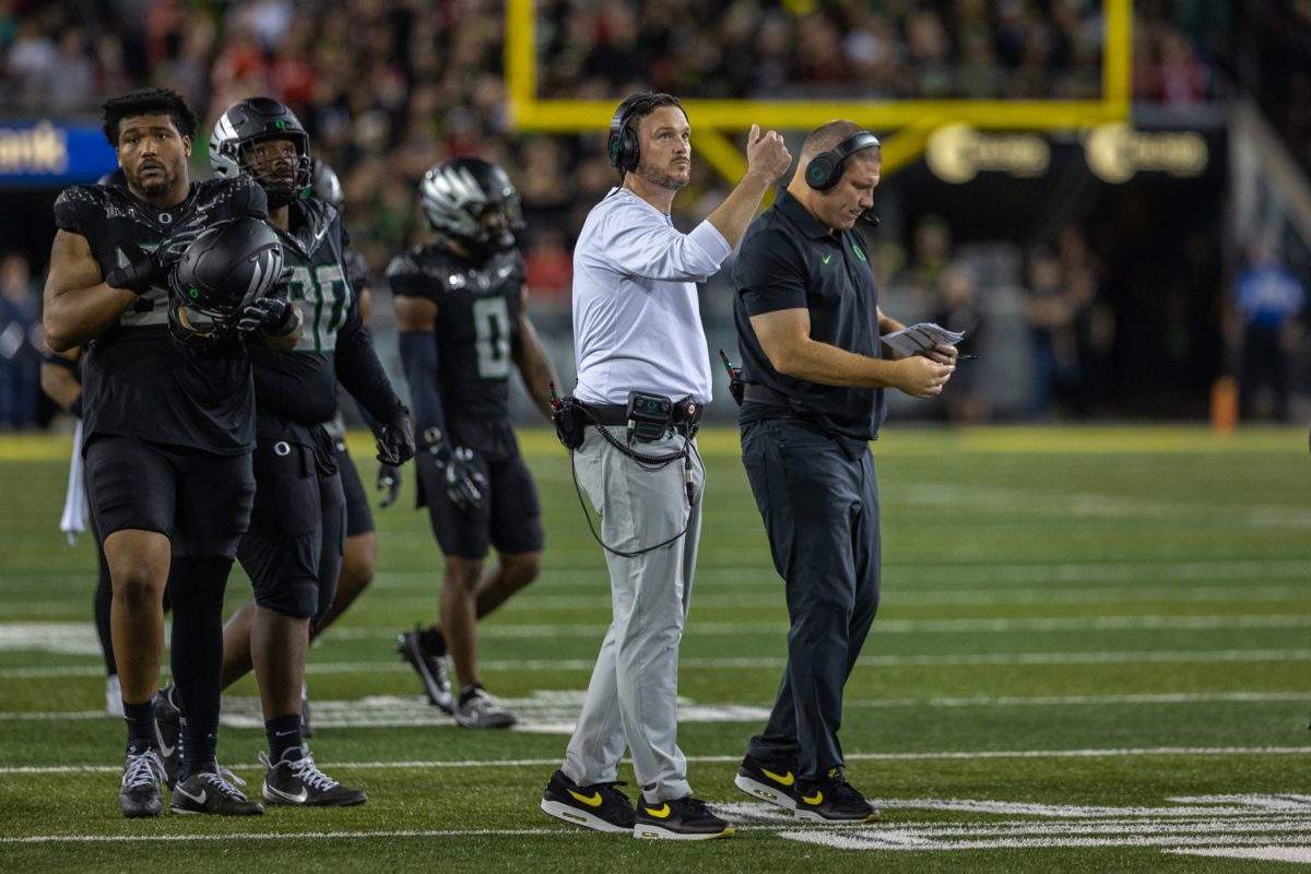 Dan Lanning calls his Ducks over to talk during a timeout. The number 3 ranked Oregon Ducks football team takes on the number 2 ranked Ohio State University Buckeyes on Oct. 12, 2024, at Autzen Stadium in Eugene, Ore. (Molly McPherson/Emerald)