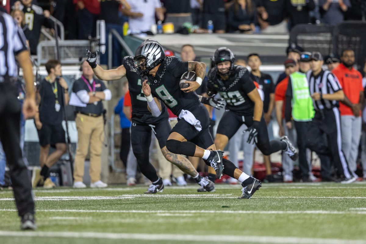 Dillon Gabriel (8) runs the ball into the endzone for a touchdown. The No. 3 ranked Oregon Ducks football team takes on the No. 2 ranked Ohio State University Buckeyes on Oct. 12, 2024, at Autzen Stadium in Eugene, Ore. (Molly McPherson/Emerald)