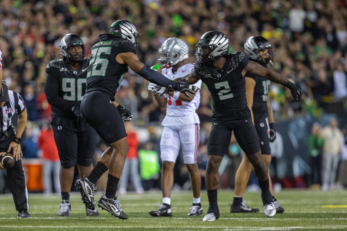 Devon Jackson (6) celebrates with Jeffrey Bassa (2) after a big play. The number 3 ranked Oregon Ducks football team takes on the number 2 ranked Ohio State University Buckeyes on Oct. 12, 2024, at Autzen Stadium in Eugene, Ore. (Molly McPherson/Emerald)