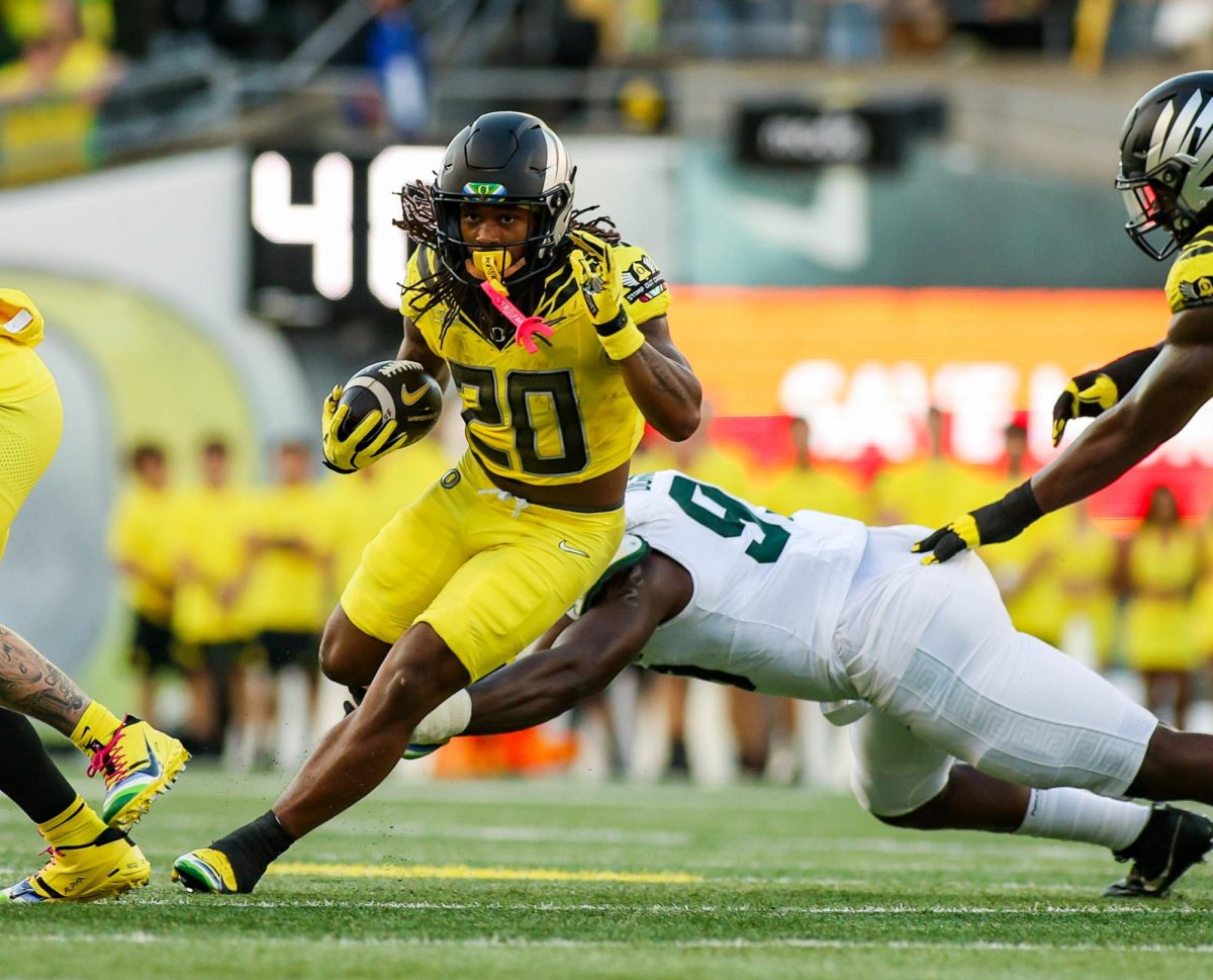 Halfback Jordan James (20) avoids the tackle. University of Oregon takes on Michigan State University at Autzen Stadium, Eugene, October 4th 2024. (Eddie Bruning/Emerald)